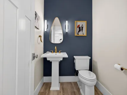 a bathroom with a sink toilet and mirror