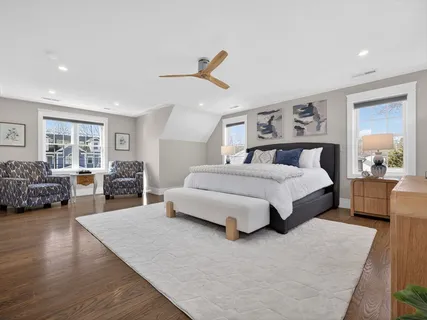 a bedroom with a large bed couch and a dresser