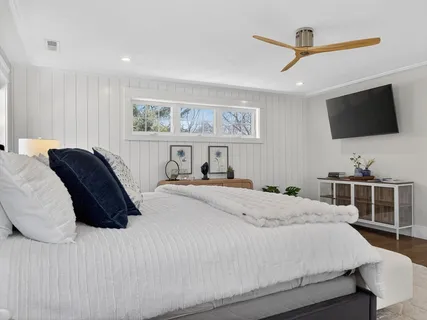 a bedroom with a bed and a flat screen tv