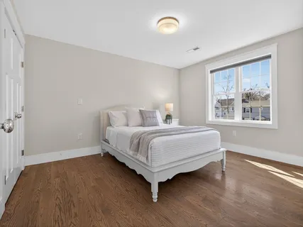 a bedroom with a bed and a night stand