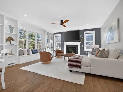 a living room with furniture fireplace and window