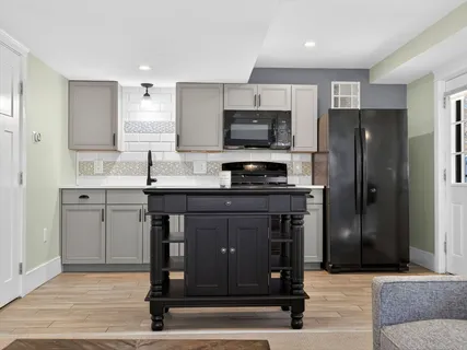 a kitchen with stainless steel appliances a stove refrigerator and microwave