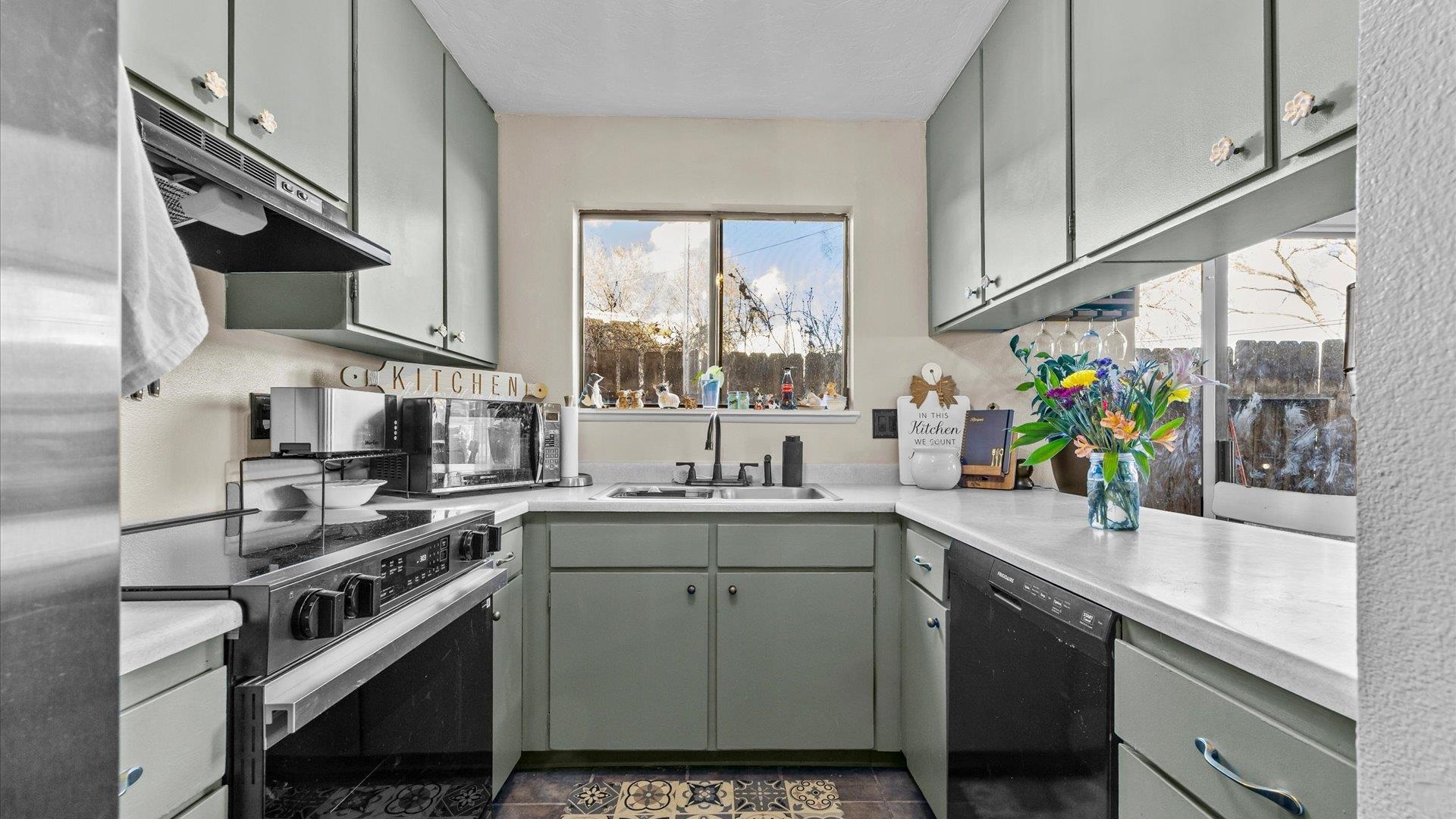 517-28 28 1/2 Road, Unit 4E Grand Junction, CO 81501 - Photo 14 of 15 a kitchen with stainless steel appliances a sink a stove and cabinets