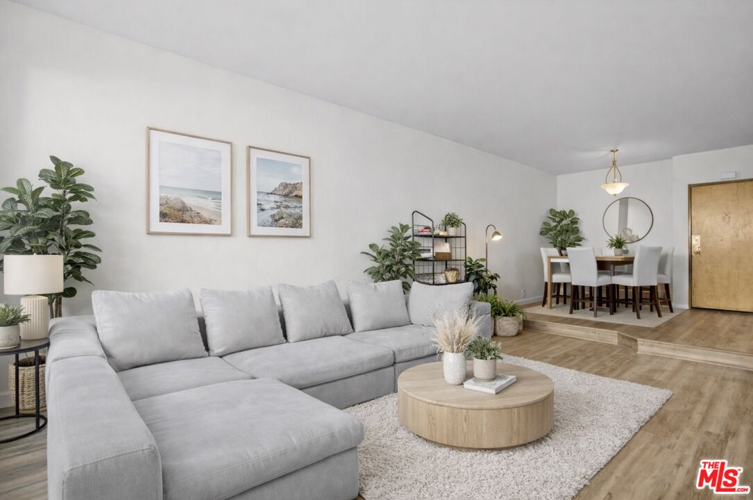 a living room with furniture potted a table and a potted plant