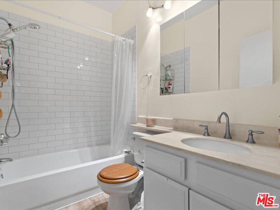 19009 Sherman Way, Unit 2 Reseda, CA 91335 - Photo 16 of 31 a bathroom with a sink and a mirror