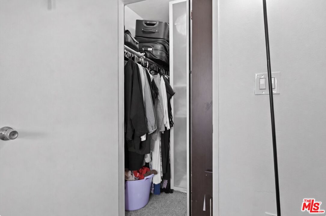 19009 Sherman Way, Unit 2 Reseda, CA 91335 - Photo 21 of 31 a view of walk in closet with clothes