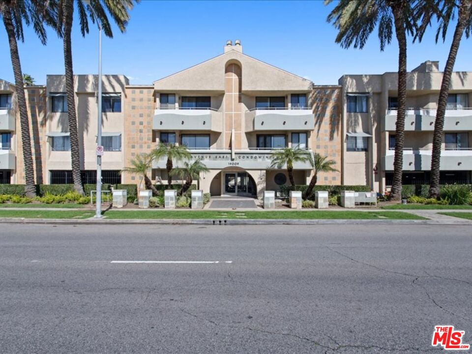 19009 Sherman Way, Unit 2 Reseda, CA 91335 - Photo 26 of 31 a front view of residential houses with yard and green space