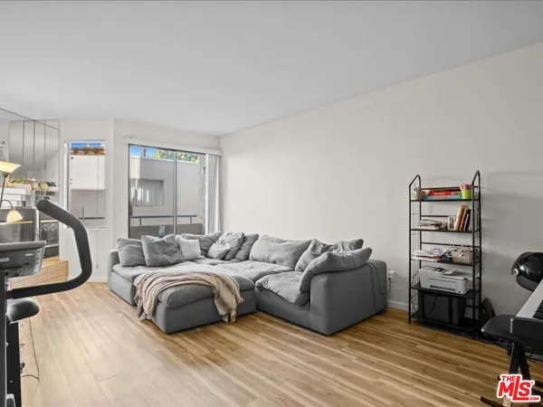 a bedroom with furniture and a wooden floor