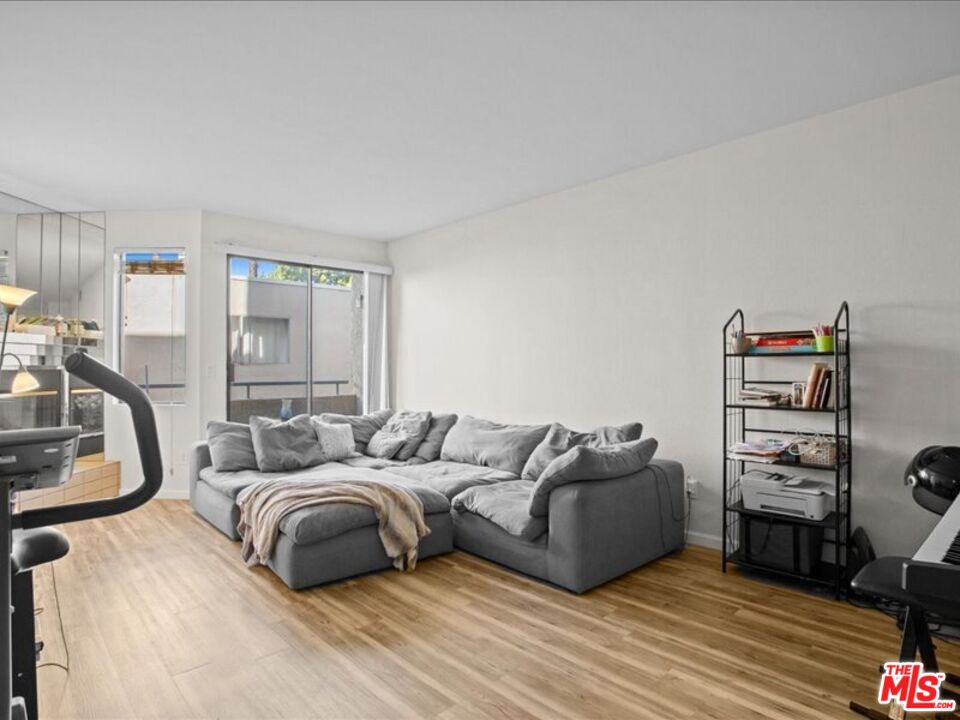 19009 Sherman Way, Unit 2 Reseda, CA 91335 - Photo 4 of 31 a bedroom with furniture and a wooden floor