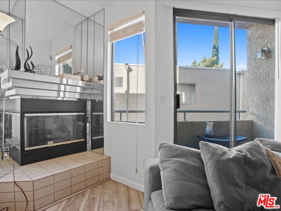 19009 Sherman Way, Unit 2 Reseda, CA 91335 - Photo 7 of 31 a living room with a couch and a fireplace