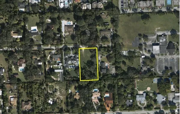 an aerial view of a residential houses with outdoor space