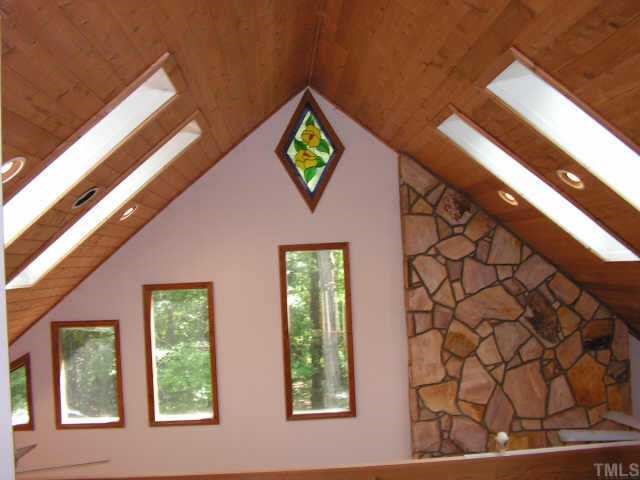 6930 Childrens Home Road Middlesex, NC 27557 - Photo 6 of 10 View of Family/Dining Room Ceiling From the Loft Shows Skylights and Stained glass accent window at peak!