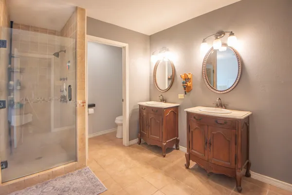 a bathroom with a sink mirror and a shower