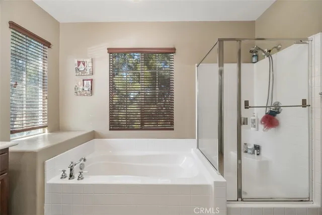 a bathroom with a bathtub and a shower