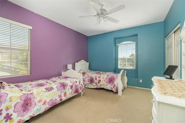 a bedroom with a bed dresser and window