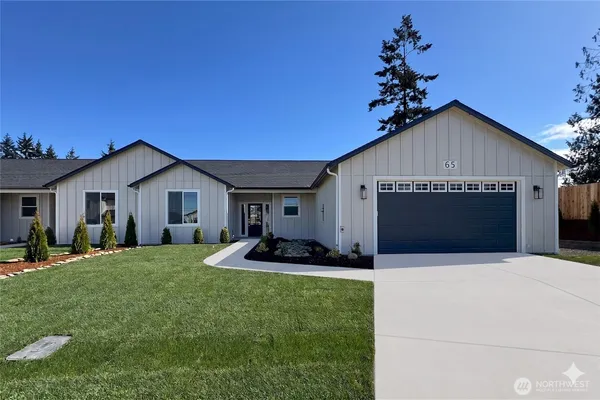 a front view of house with yard and outdoor seating