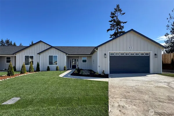 a front view of house with yard and garage