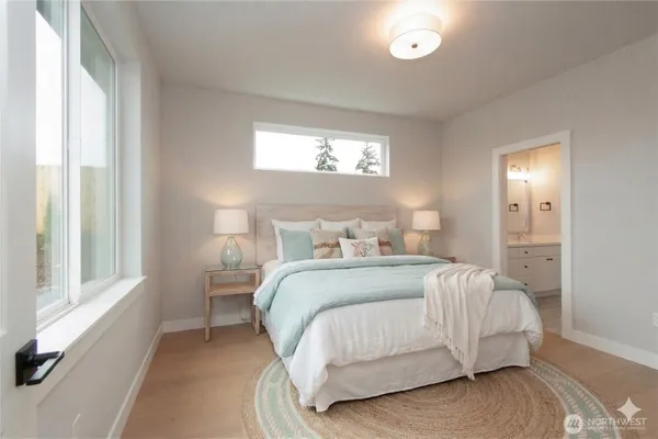 a spacious bathroom with double vanity and a mirror