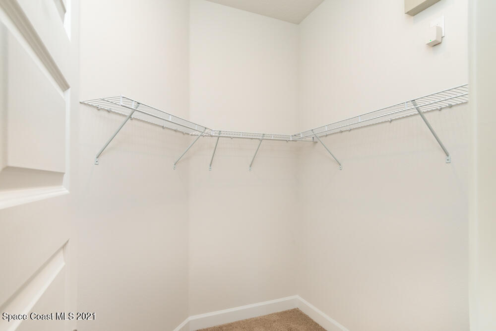 991 Tupelo Circle Cocoa, FL 32926 - Photo 14 of 23 a view of a room with racks on the wall