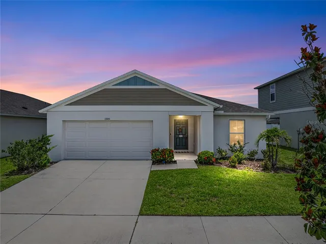 a front view of a house with a yard and garage