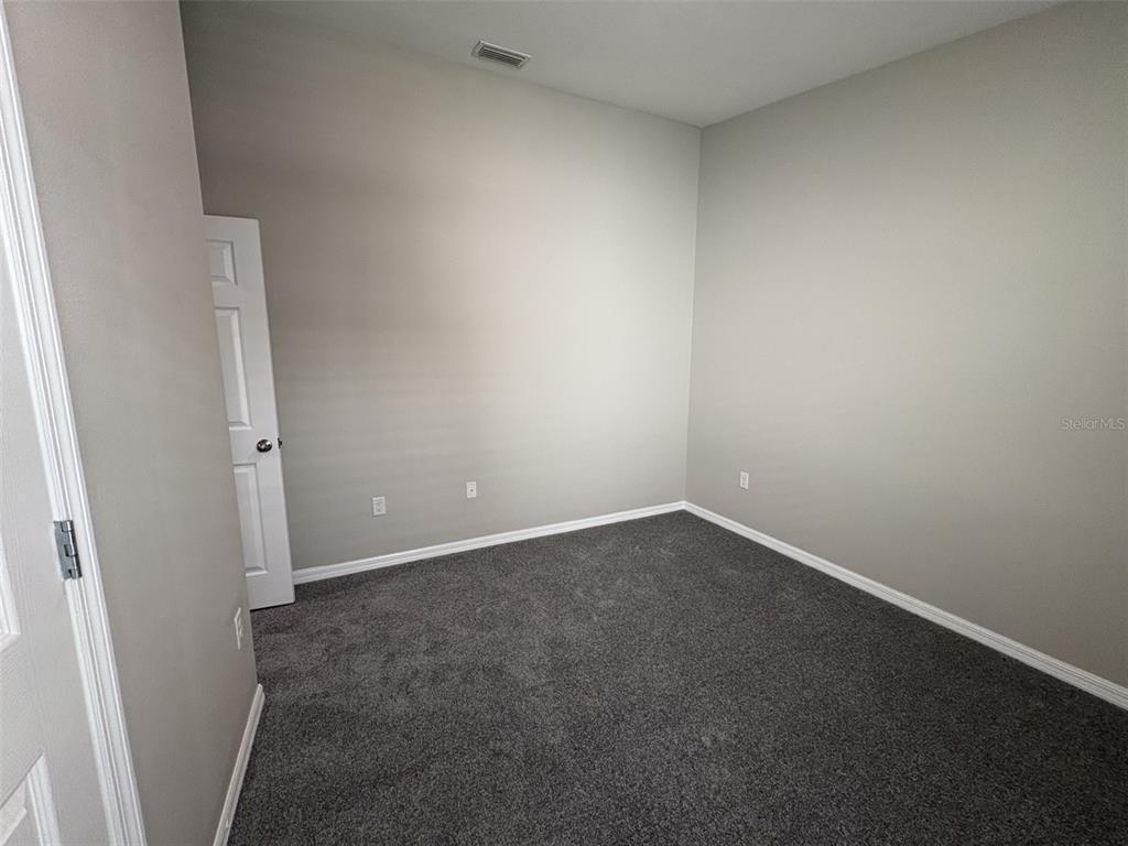 13105 Fruitville Way Riverview, FL 33579 - Photo 20 of 56 an empty room with an entrance and door