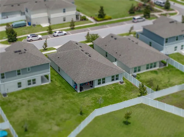 an aerial view of a house with pool