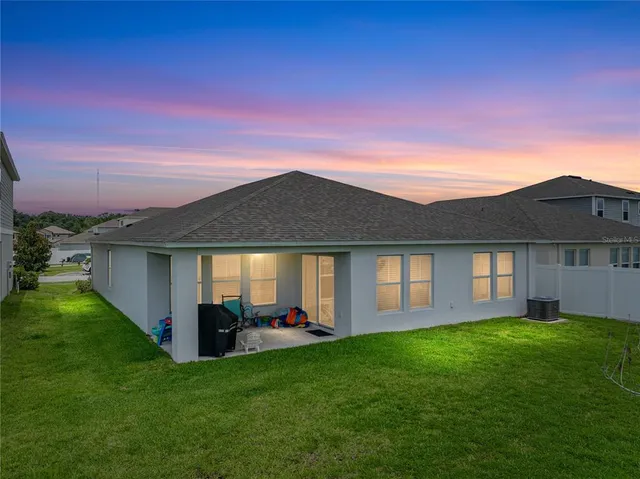 a view of a house with a backyard