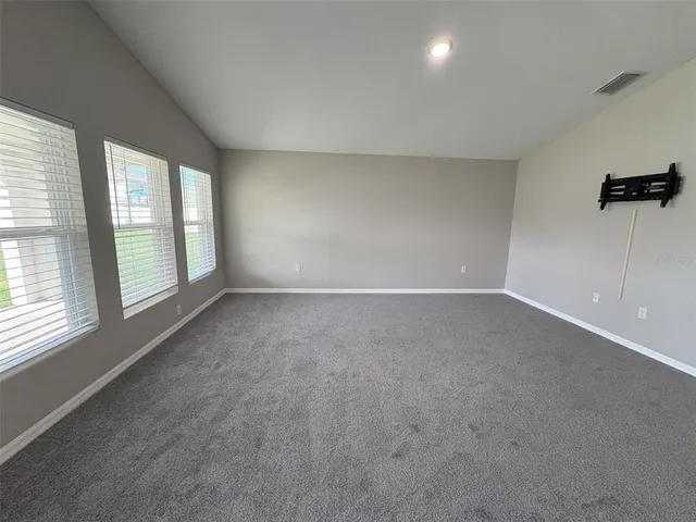 an empty room with windows and entrance