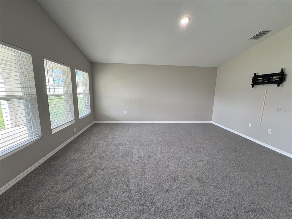 13105 Fruitville Way Riverview, FL 33579 - Photo 8 of 56 an empty room with windows