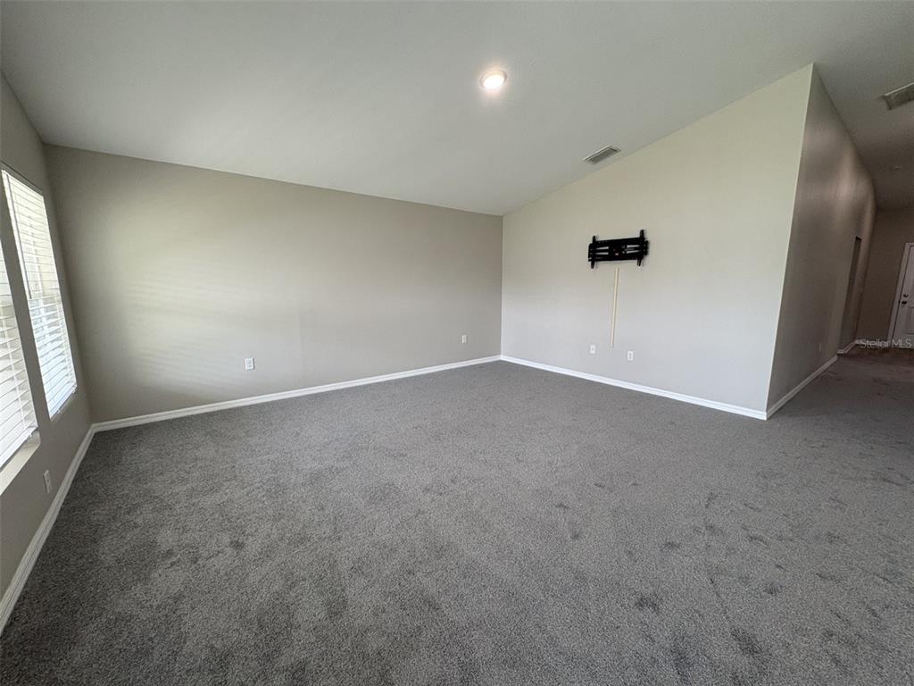 13105 Fruitville Way Riverview, FL 33579 - Photo 9 of 56 an empty room with windows and entrance