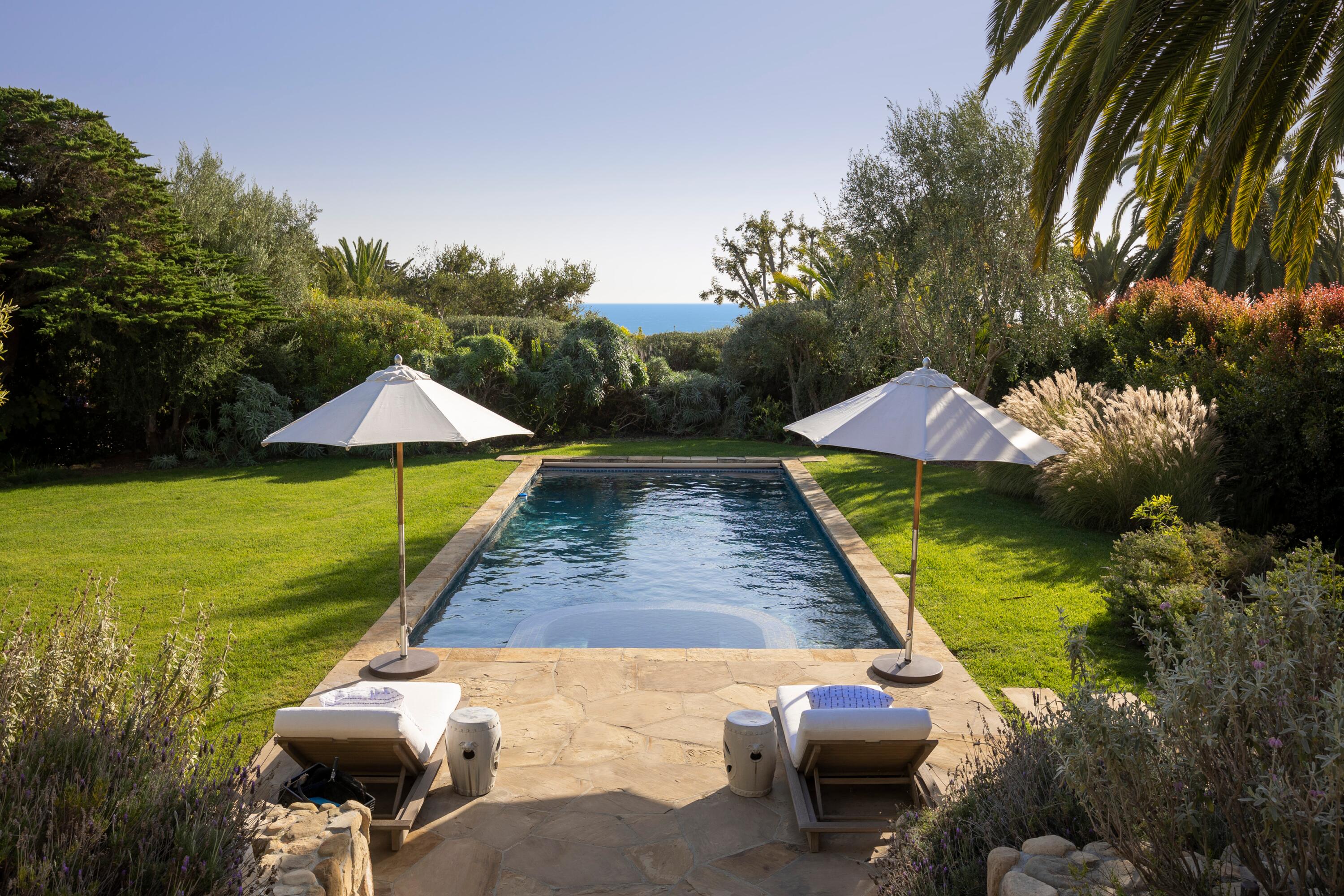 4110 Creciente Drive Santa Barbara, CA 93110 - Photo 2 of 27 a view of swimming pool with lawn chairs under an umbrella
