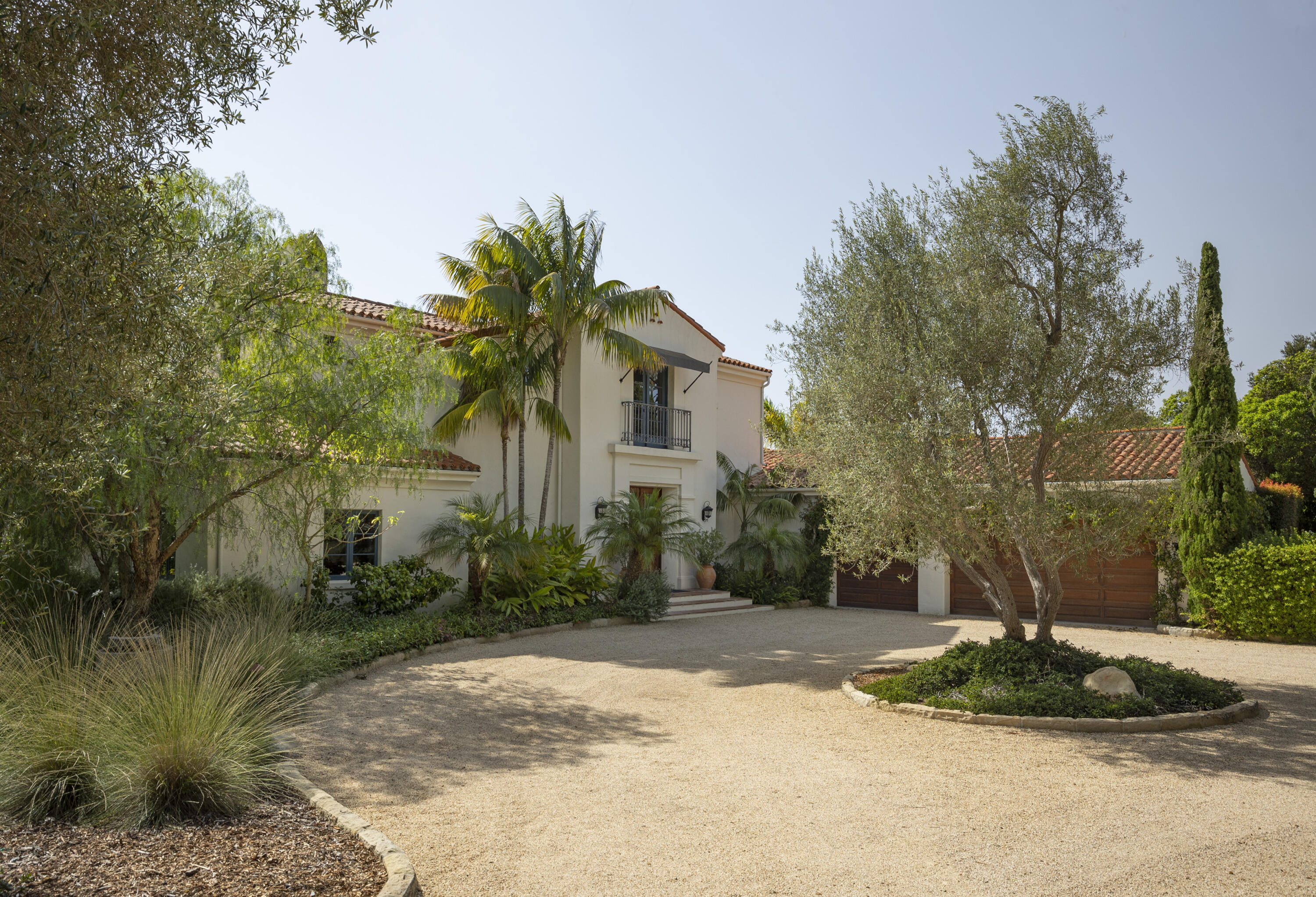 4110 Creciente Drive Santa Barbara, CA 93110 - Photo 5 of 27 a front view of a house with a yard and trees
