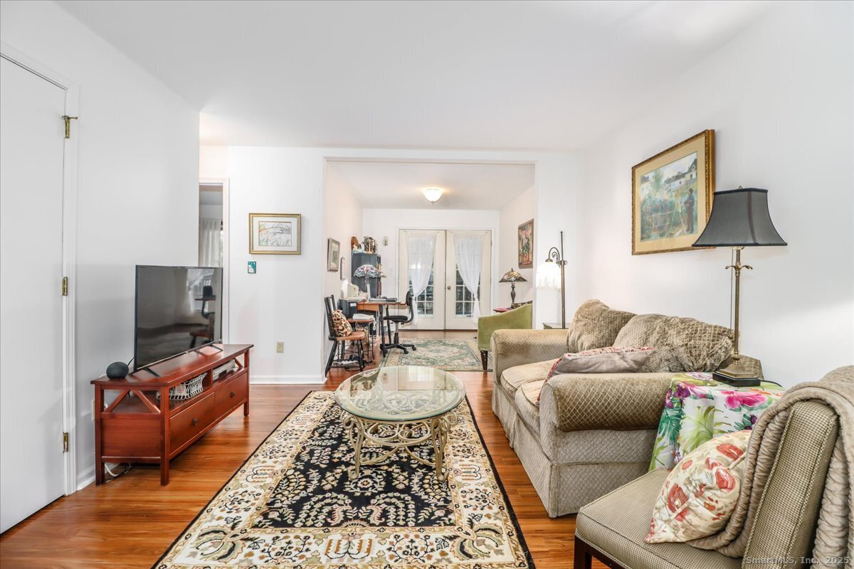 107 Hidden Knolls Circle, Unit 107 Monroe, CT 06468 - Photo 11 of 31 a living room with furniture and a flat screen tv