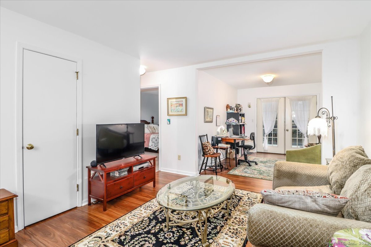 107 Hidden Knolls Circle, Unit 107 Monroe, CT 06468 - Photo 12 of 31 a living room with furniture and a flat screen tv