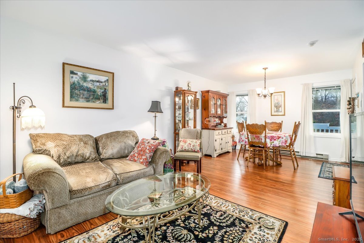 107 Hidden Knolls Circle, Unit 107 Monroe, CT 06468 - Photo 13 of 31 a living room with furniture and wooden floor