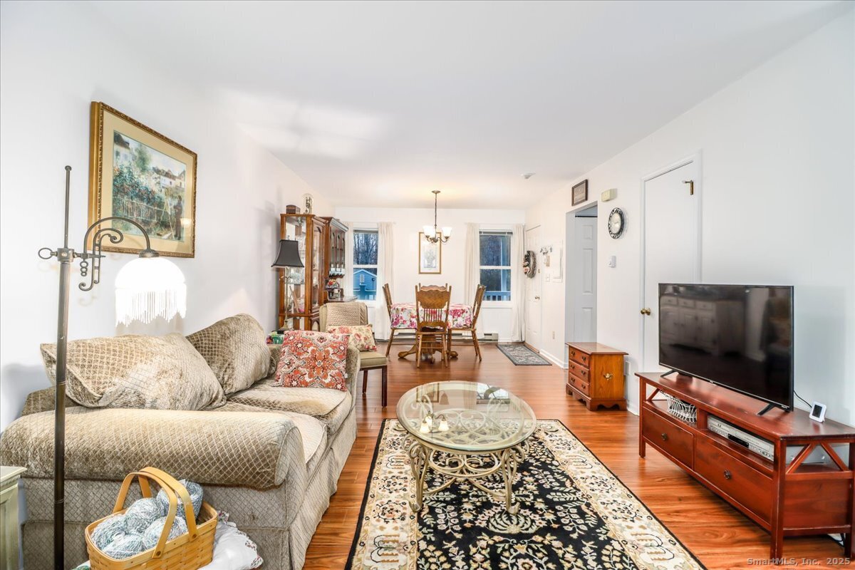 107 Hidden Knolls Circle, Unit 107 Monroe, CT 06468 - Photo 14 of 31 a living room with furniture and a flat screen tv