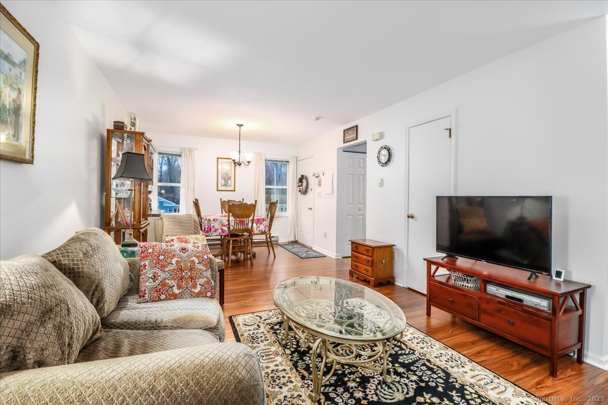 107 Hidden Knolls Circle, Unit 107 Monroe, CT 06468 - Photo 15 of 31 a living room with furniture and a flat screen tv