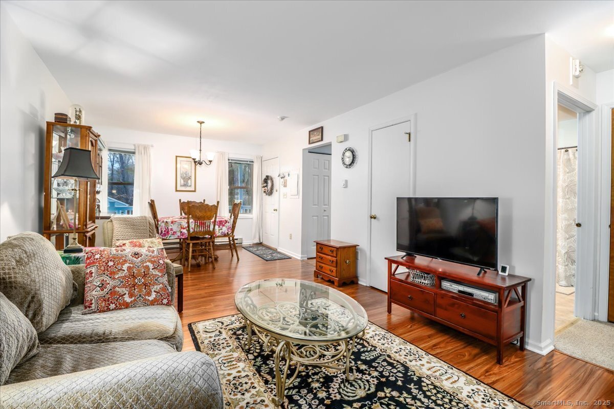 107 Hidden Knolls Circle, Unit 107 Monroe, CT 06468 - Photo 16 of 31 a living room with furniture and a flat screen tv