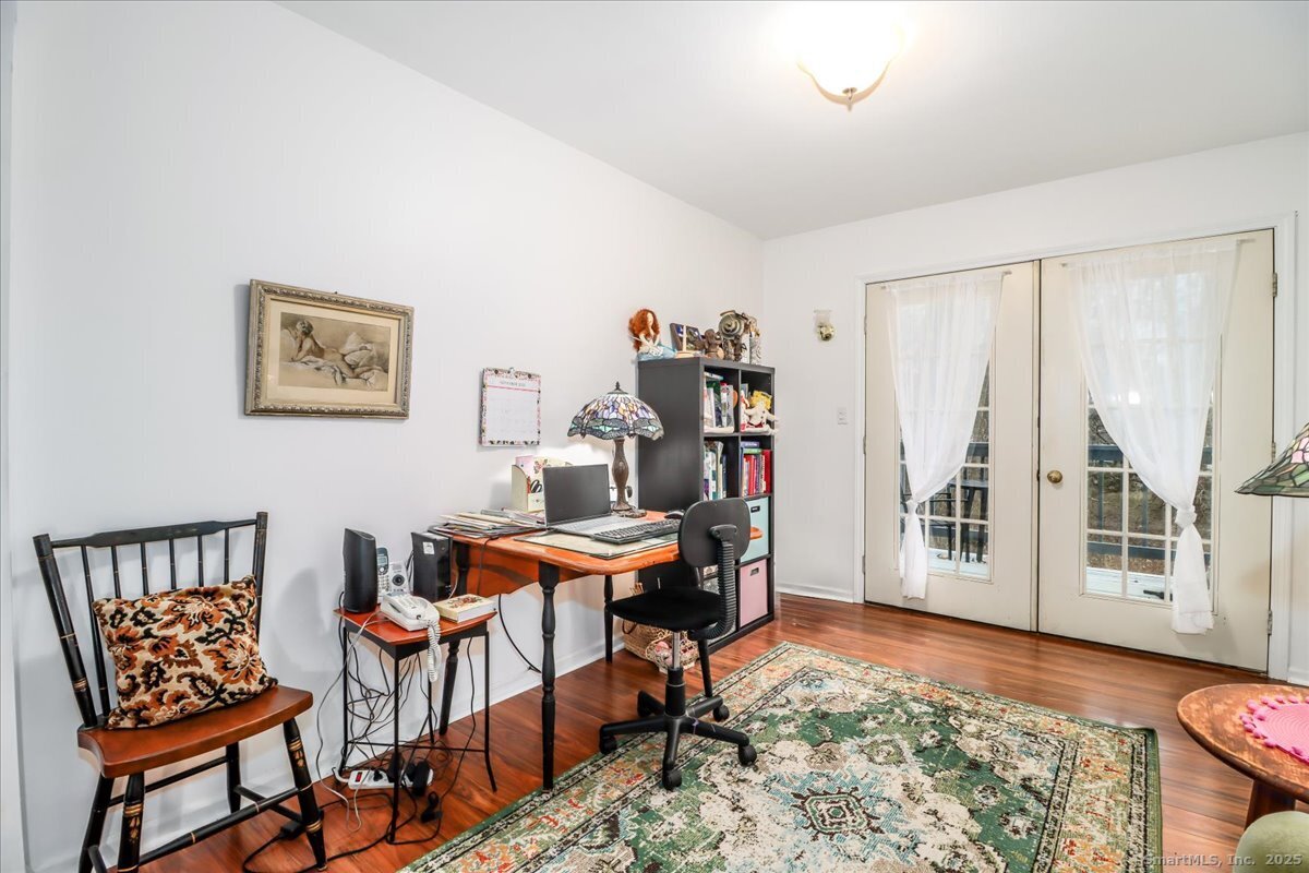 107 Hidden Knolls Circle, Unit 107 Monroe, CT 06468 - Photo 19 of 31 a room with furniture and a rug