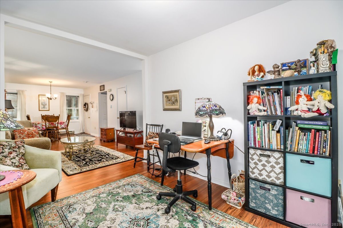 107 Hidden Knolls Circle, Unit 107 Monroe, CT 06468 - Photo 20 of 31 a living room with furniture and a book shelf