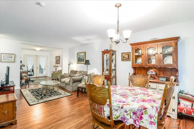 a living room with fireplace furniture and a chandelier