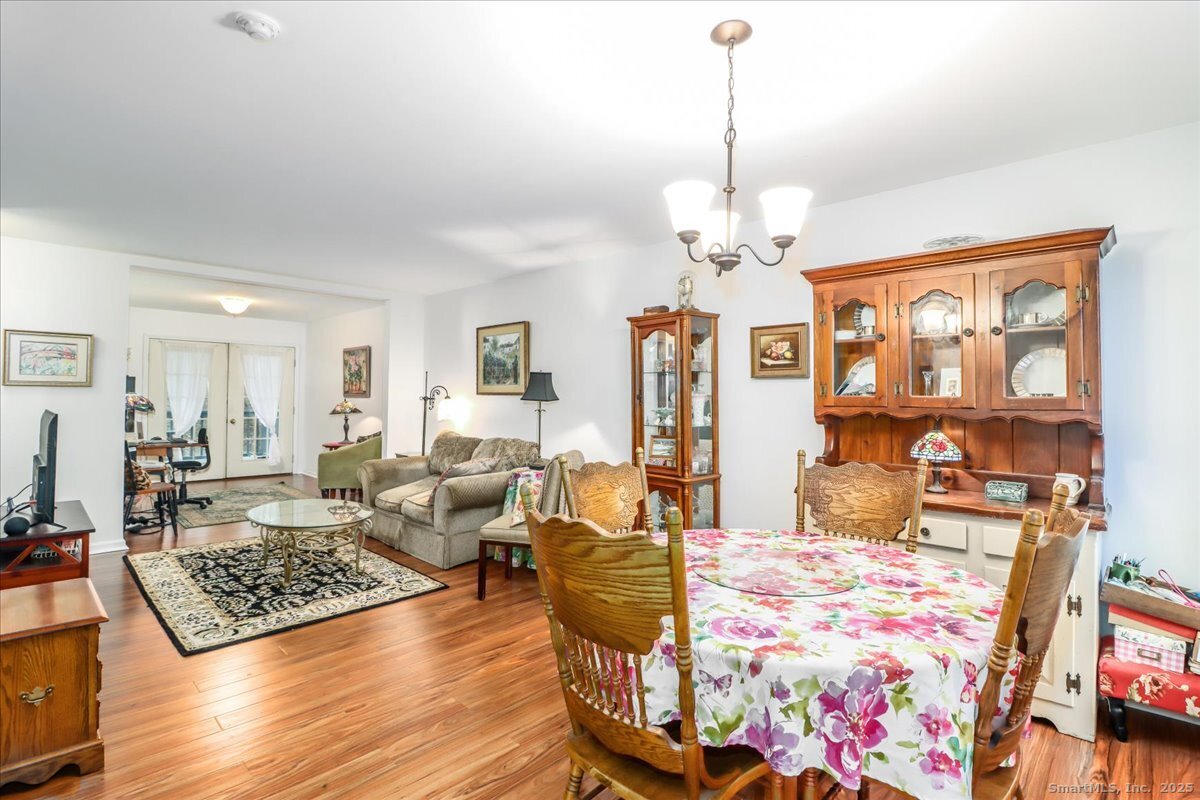 107 Hidden Knolls Circle, Unit 107 Monroe, CT 06468 - Photo 21 of 31 a living room with fireplace furniture and a chandelier