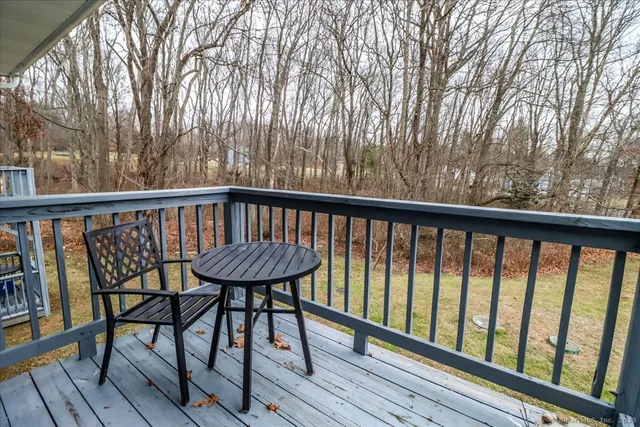 a view of a balcony with furniture and wooden floor