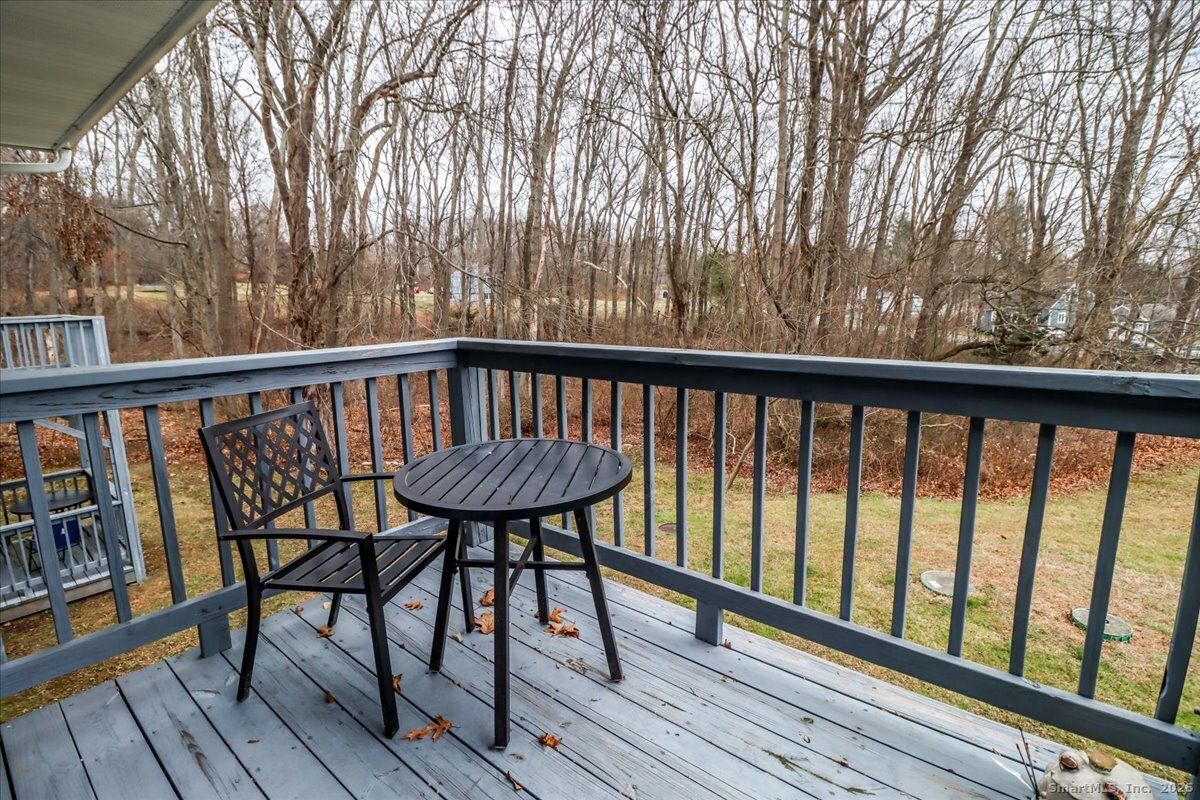 107 Hidden Knolls Circle, Unit 107 Monroe, CT 06468 - Photo 27 of 31 a view of balcony with wooden floor and outdoor seating