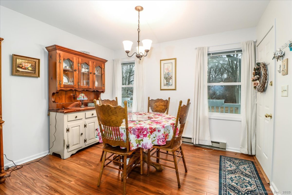 107 Hidden Knolls Circle, Unit 107 Monroe, CT 06468 - Photo 7 of 31 a view of a dining room with furniture window and wooden floor
