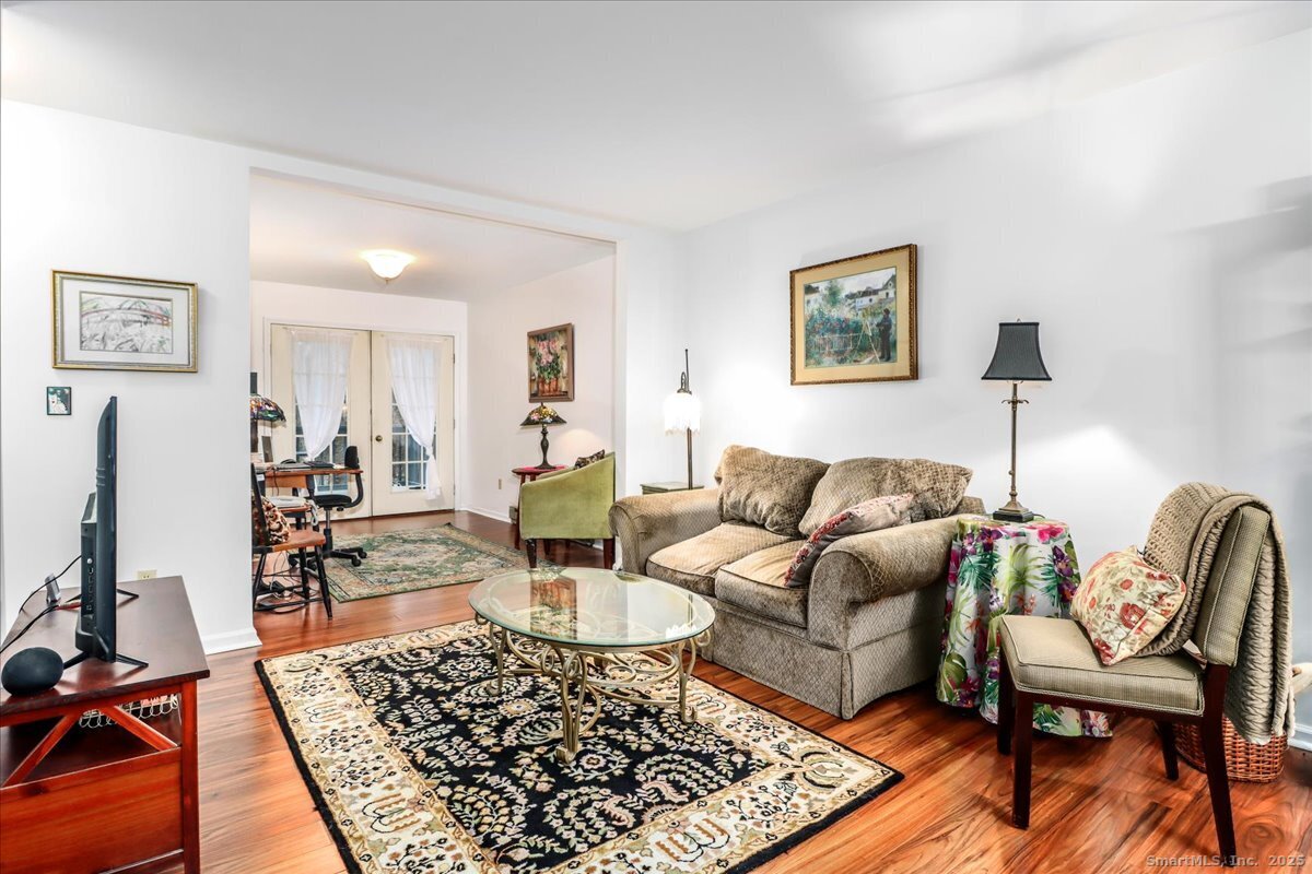107 Hidden Knolls Circle, Unit 107 Monroe, CT 06468 - Photo 10 of 31 a living room with furniture and wooden floor