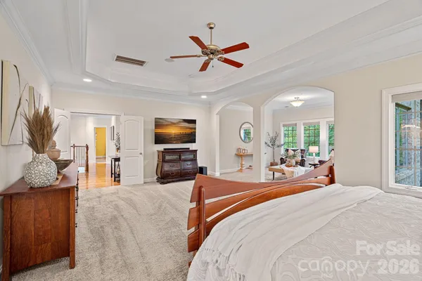 a bedroom with a bed and ceiling fan