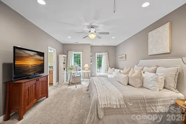 a bedroom with furniture and a flat screen tv