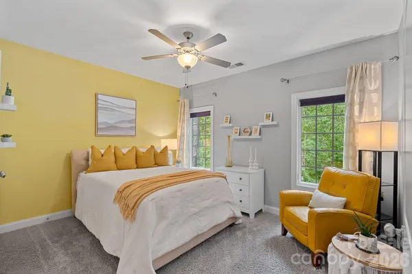 a bedroom with a bed and a couch
