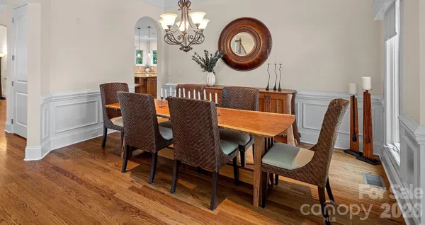 a view of a dining room with furniture and chandelier